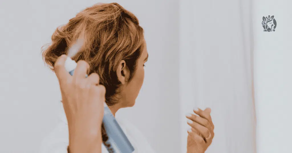 women spraying hair before blow dry