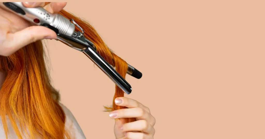 Close-up of rotating curling iron wrapping hair automatically